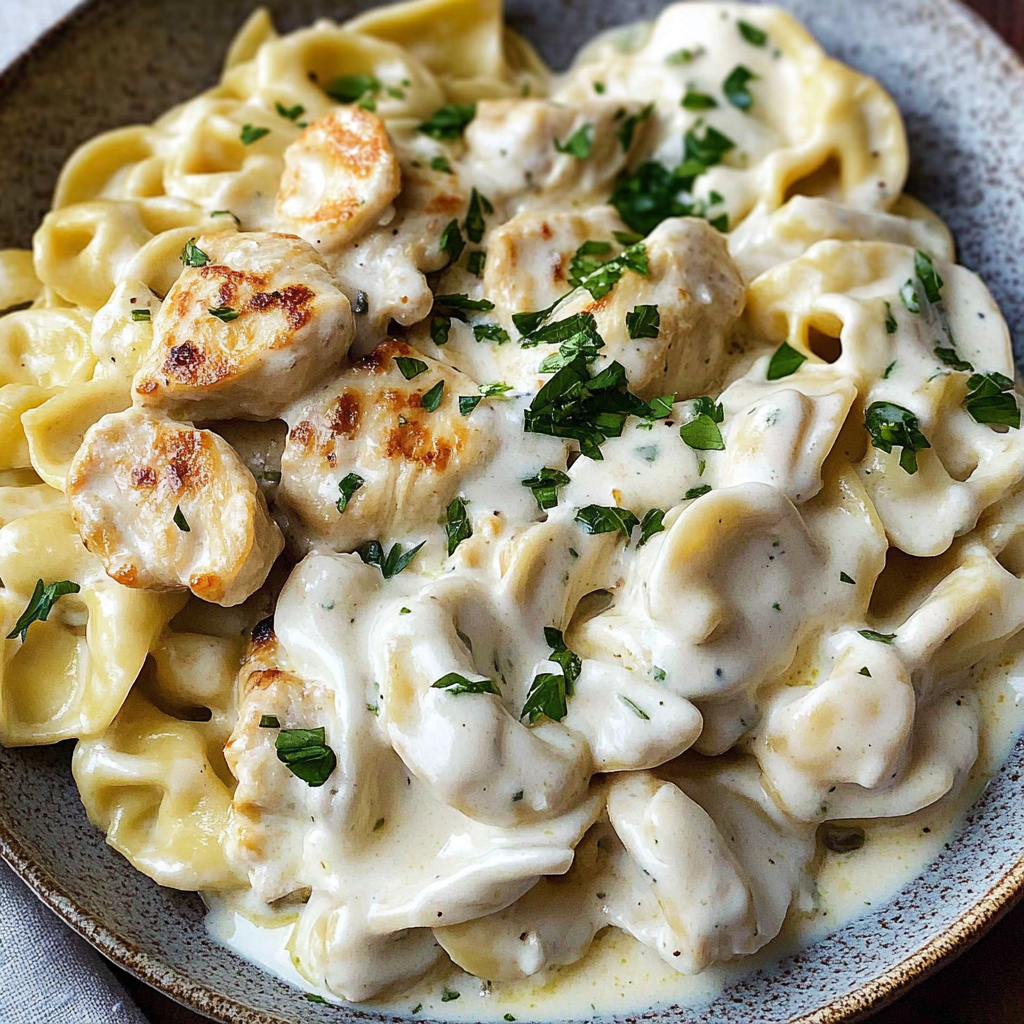 Recipe preparation for Spicy Garlic Chicken Tortellini in Cheesy Alfredo Cream